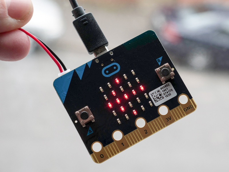 Image of the Micro:bit v2 board lit up